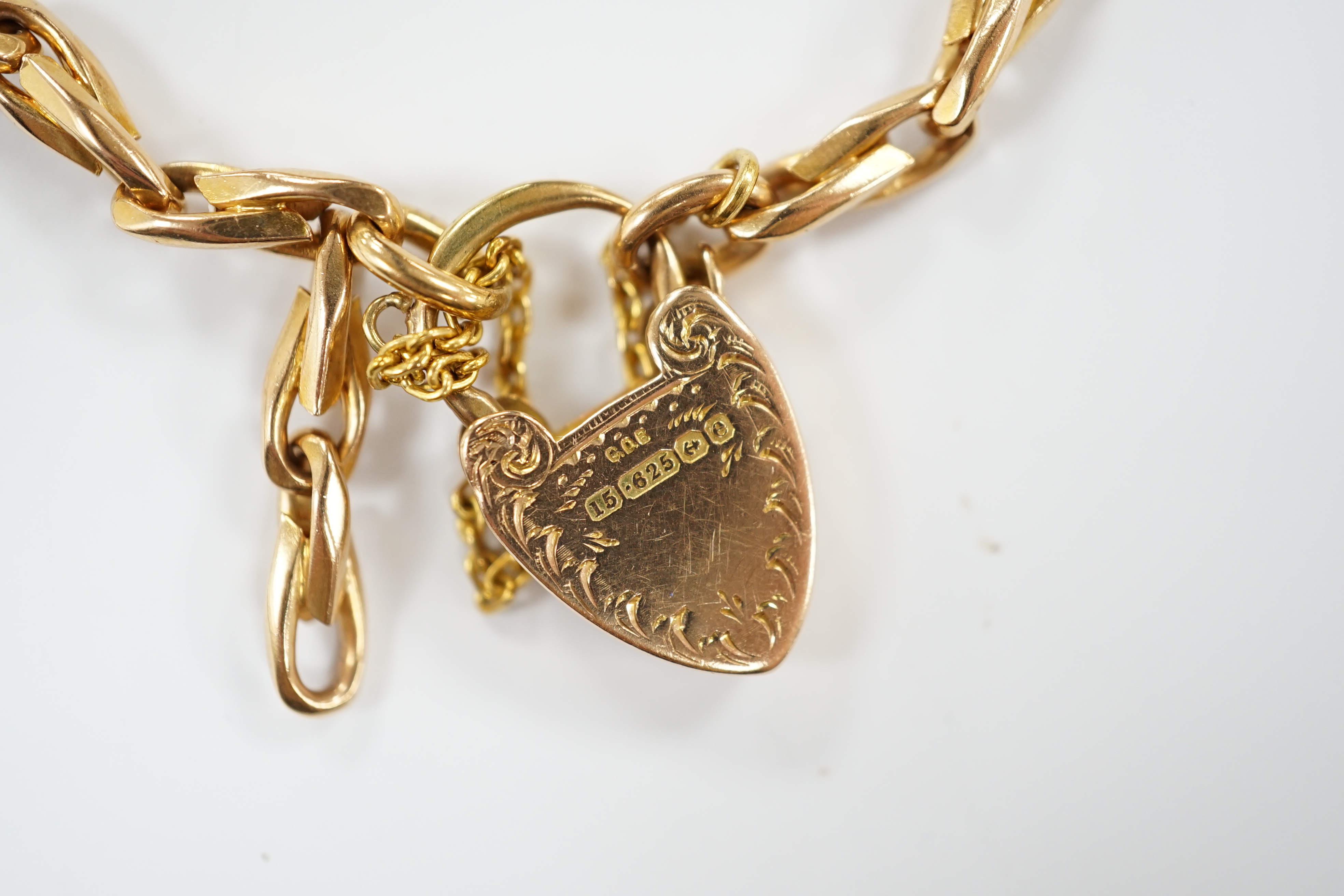 An Edwardian 15ct gold oval link bracelet with heart shape padlock clasp, 18cm, 24.6 grams.